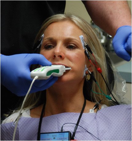 Woman receiving digital occlusal analysis with images on computer